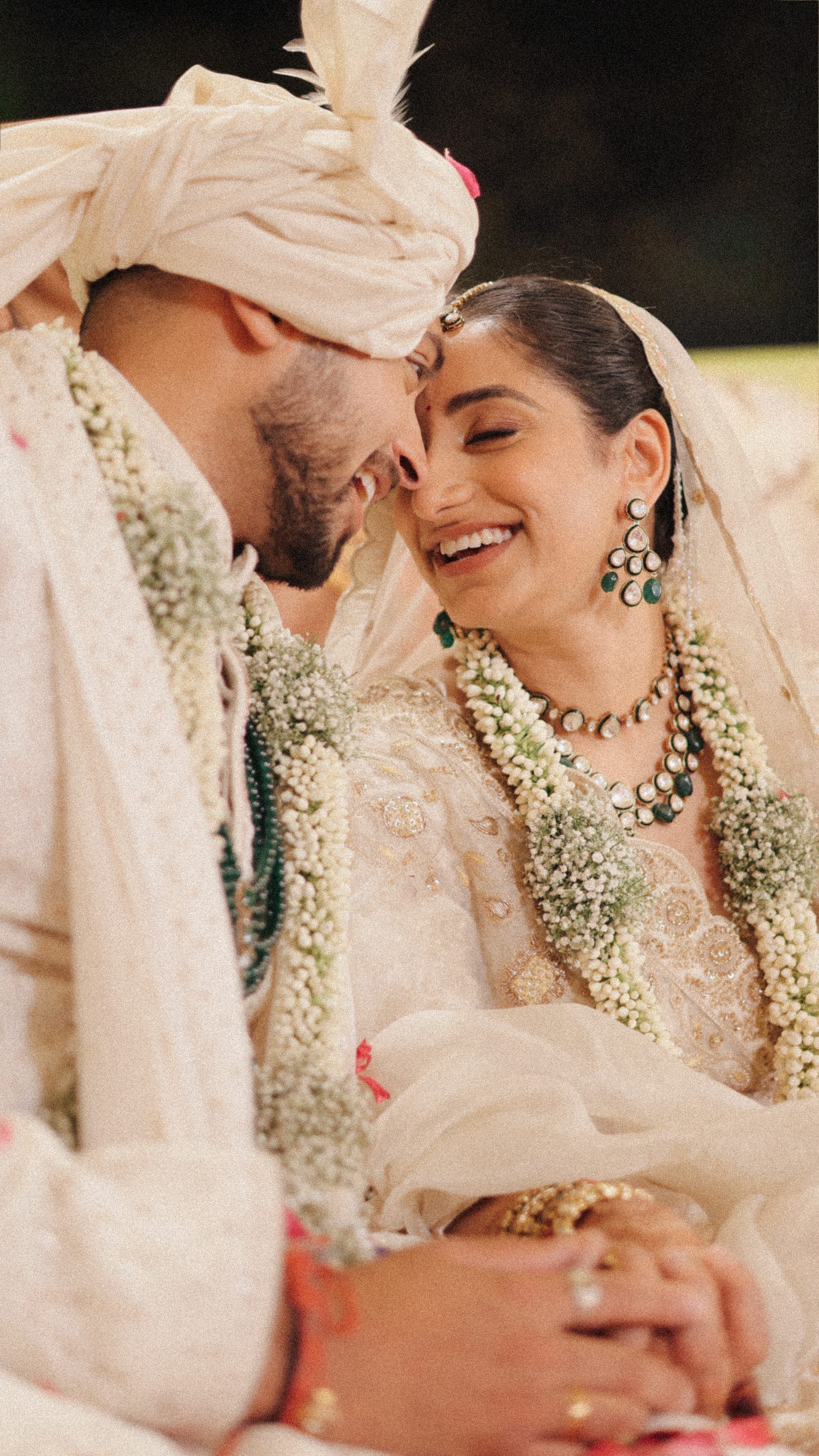 Bride and groom embracing at the reception table