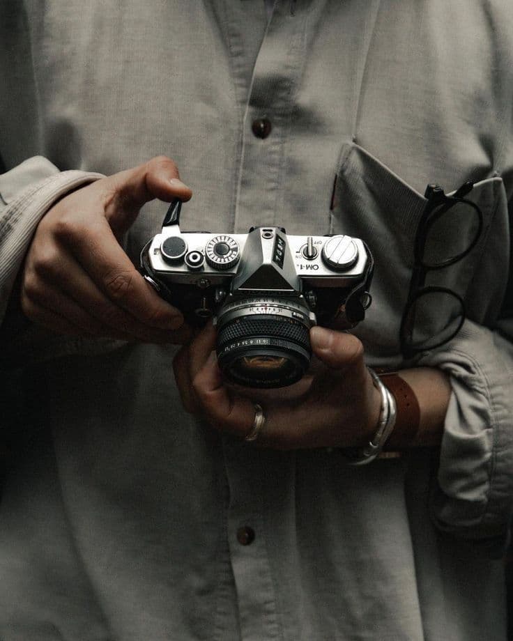Hands holding a vintage film camera
